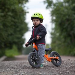 Child in helmet ride balance bike (run bike)